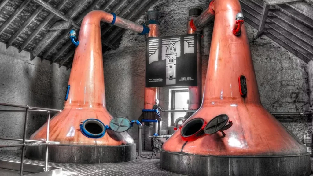 Copper pot stills inside a traditional whisky distillery