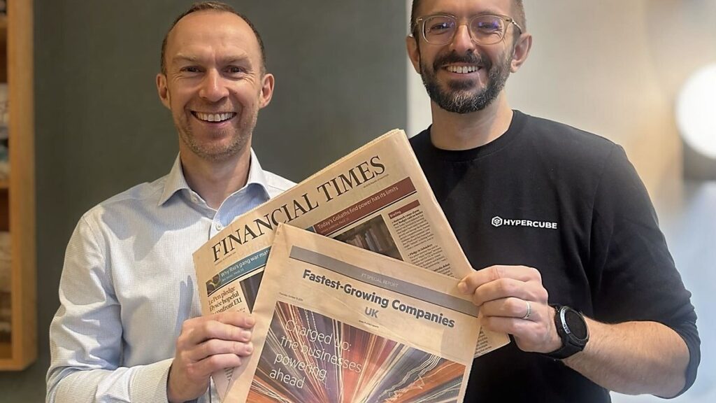 Hypercube co-founders Adam Sroka and Iain Cherry holding the Financial Times fastest-growing companies edition